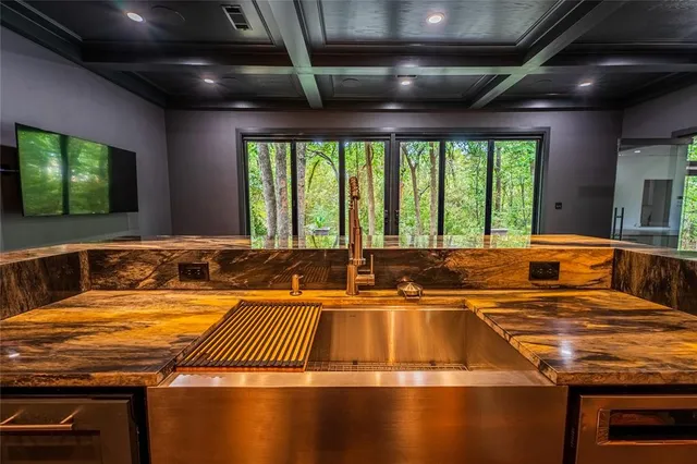 a view of a kitchen with a large window and a sink