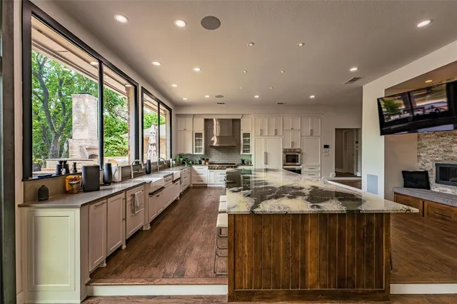 a kitchen with counter top space a sink and appliances