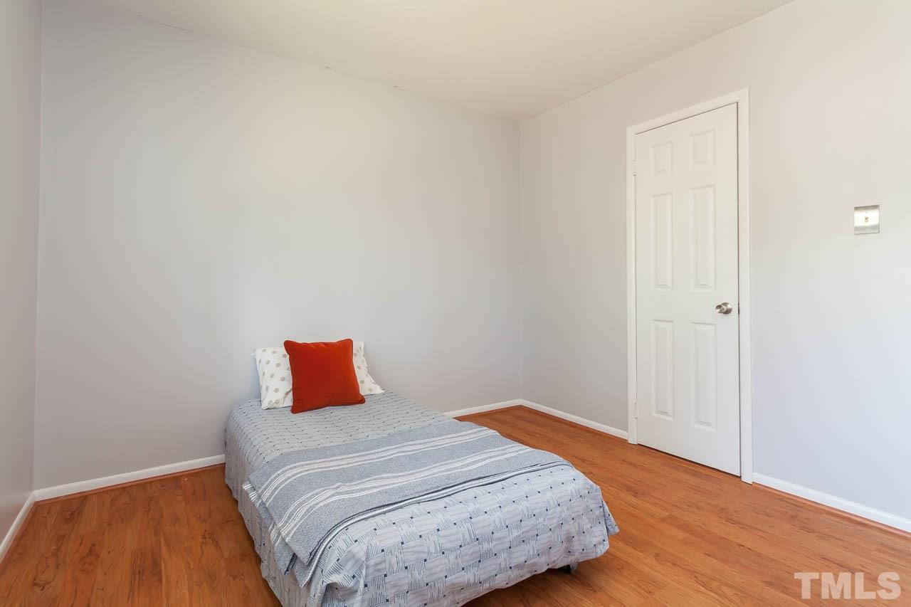859 Hadley Road Raleigh, NC 27610 - Photo 11 of 17 The 3rd bedroom has wood laminate flooring to match the public spaces.