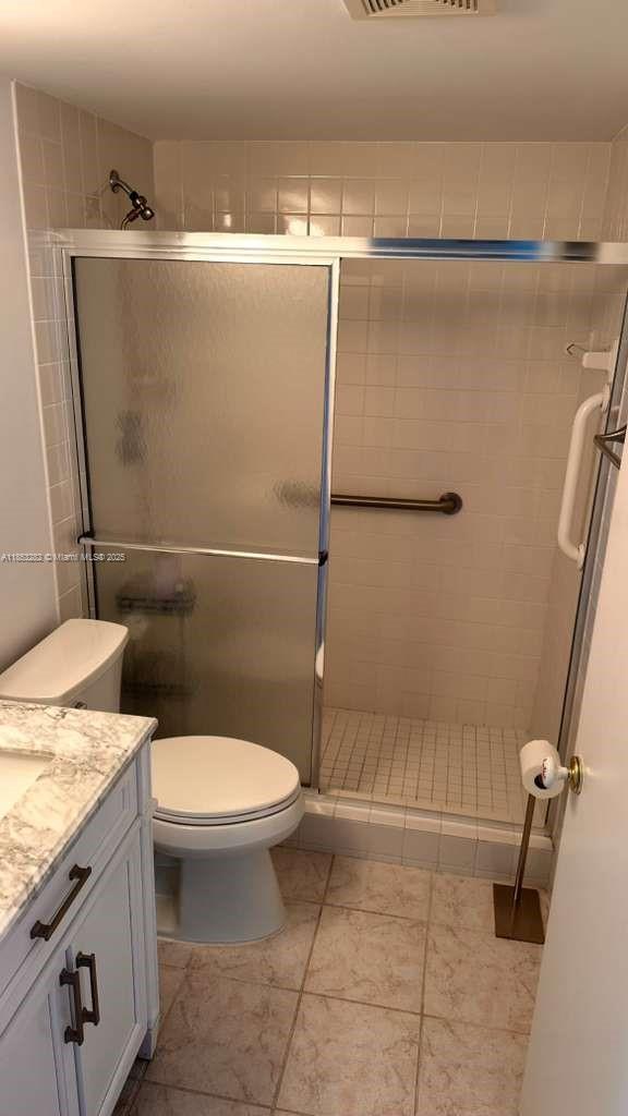 4050 Ainslie Drive, Unit 4050 Boca Raton, FL 33434 - Photo 13 of 17 a bathroom with a granite countertop sink toilet and shower