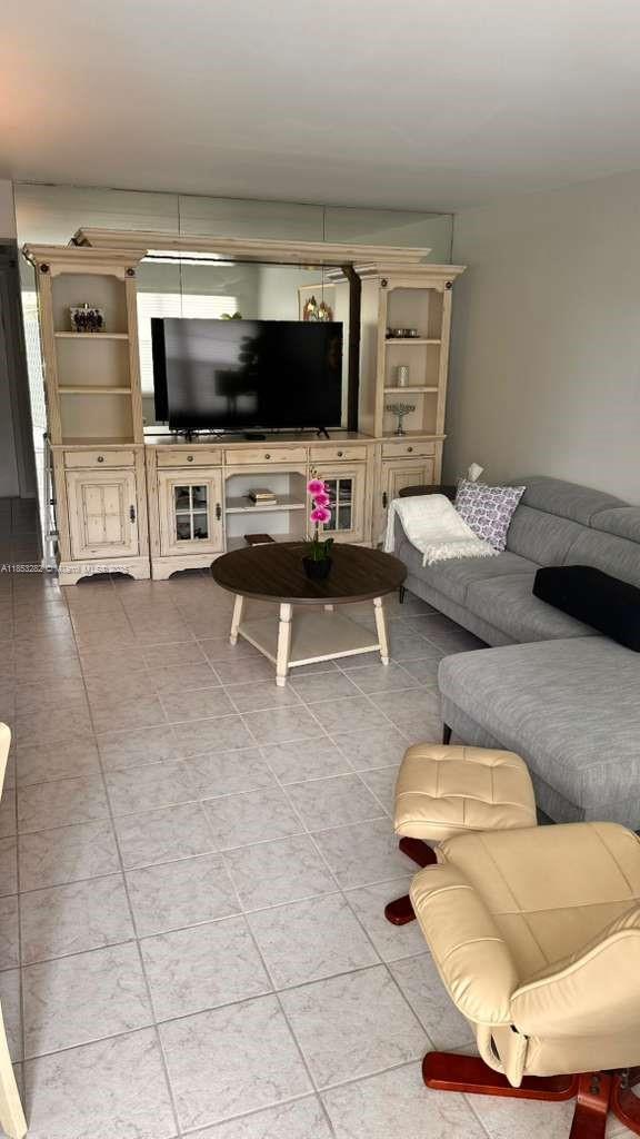 4050 Ainslie Drive, Unit 4050 Boca Raton, FL 33434 - Photo 3 of 17 a living room with furniture and a flat screen tv