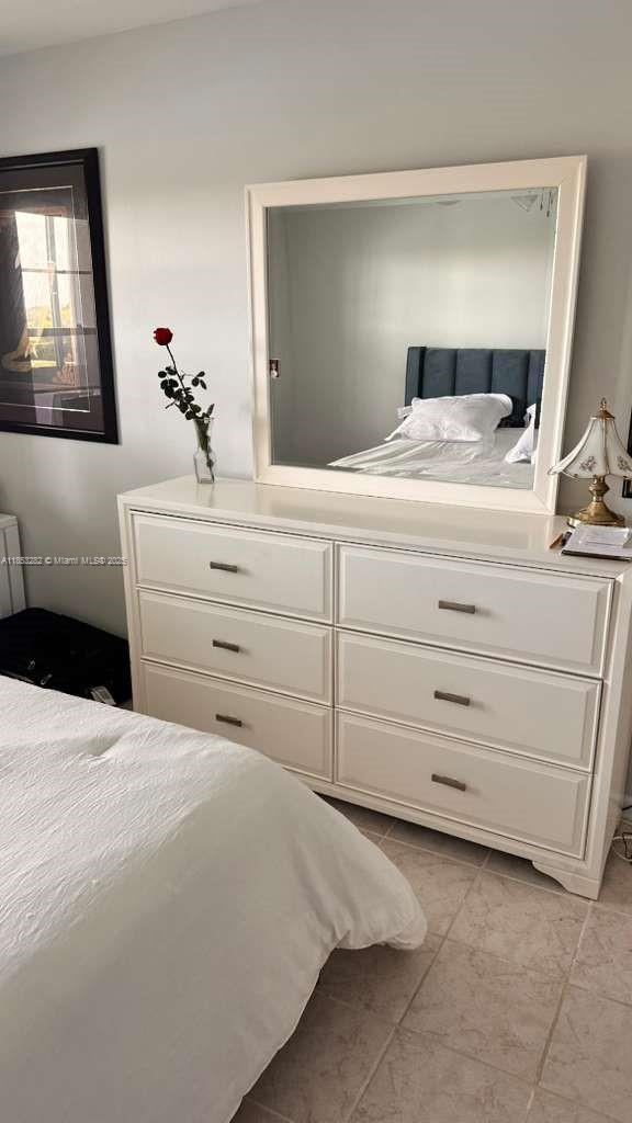 4050 Ainslie Drive, Unit 4050 Boca Raton, FL 33434 - Photo 10 of 17 a bedroom with a large bed and a mirror