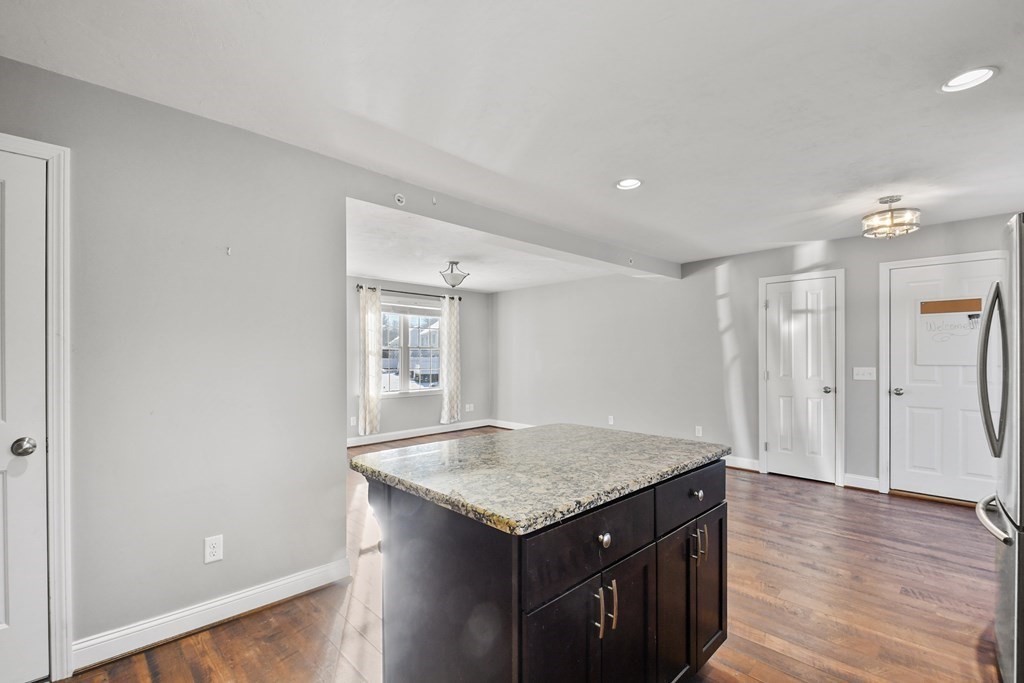 211 Barre Paxton Road, Unit 2 Rutland, MA 01543 - Photo 11 of 30 a kitchen with a wooden floor and a sink