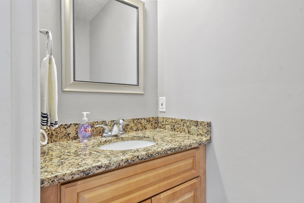 211 Barre Paxton Road, Unit 2 Rutland, MA 01543 - Photo 12 of 30 a bathroom with a granite countertop sink and a mirror