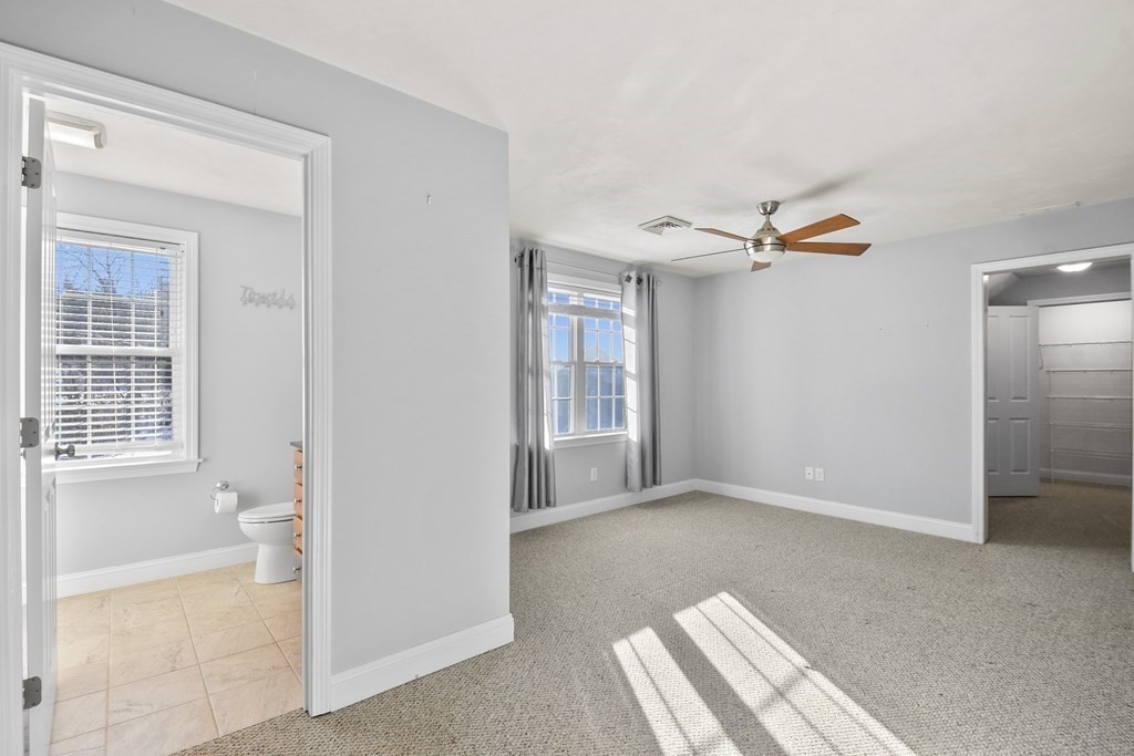 211 Barre Paxton Road, Unit 2 Rutland, MA 01543 - Photo 13 of 30 a view of empty room with wooden floor and fan