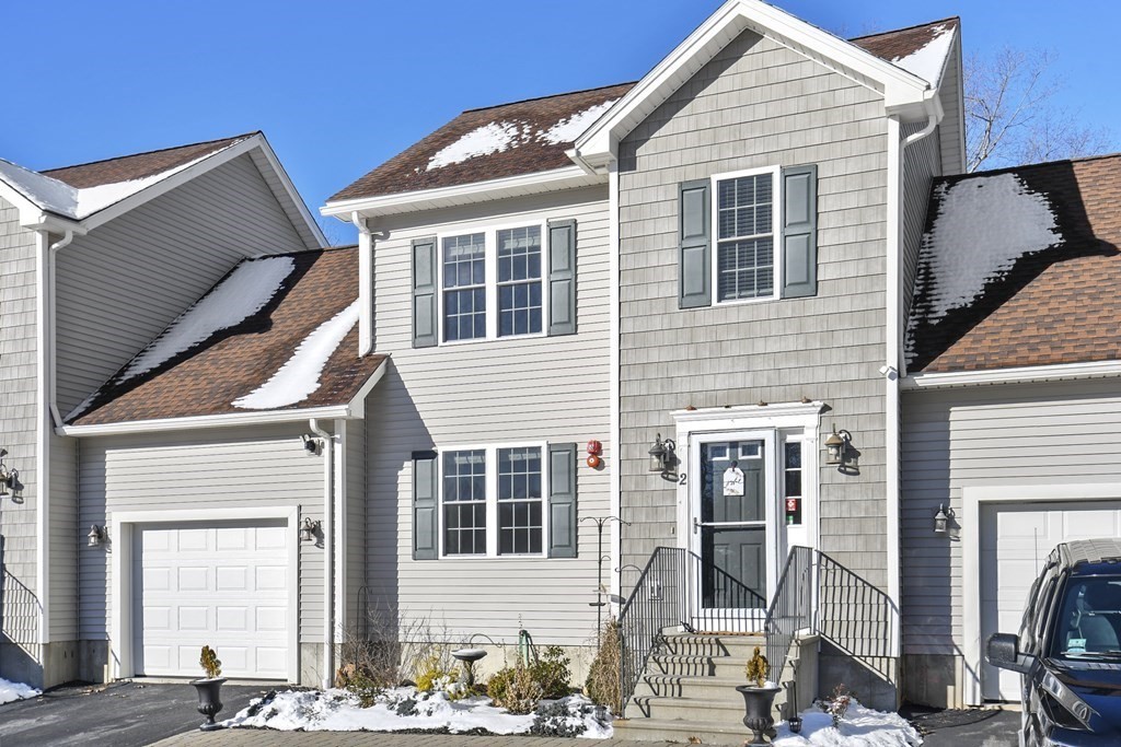 211 Barre Paxton Road, Unit 2 Rutland, MA 01543 - Photo 2 of 30 a front view of a house with a yard