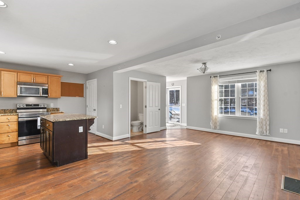 211 Barre Paxton Road, Unit 2 Rutland, MA 01543 - Photo 7 of 30 a view of a kitchen with wooden floor and a window