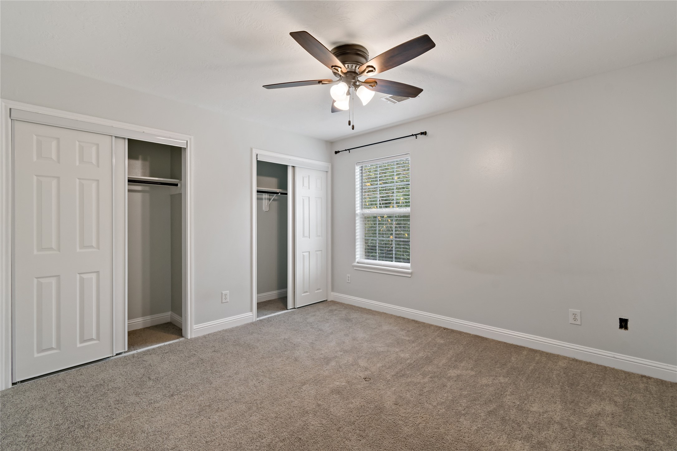 507 Firnat Street Houston, TX 77022 - Photo 12 of 22 an empty room with windows and fan