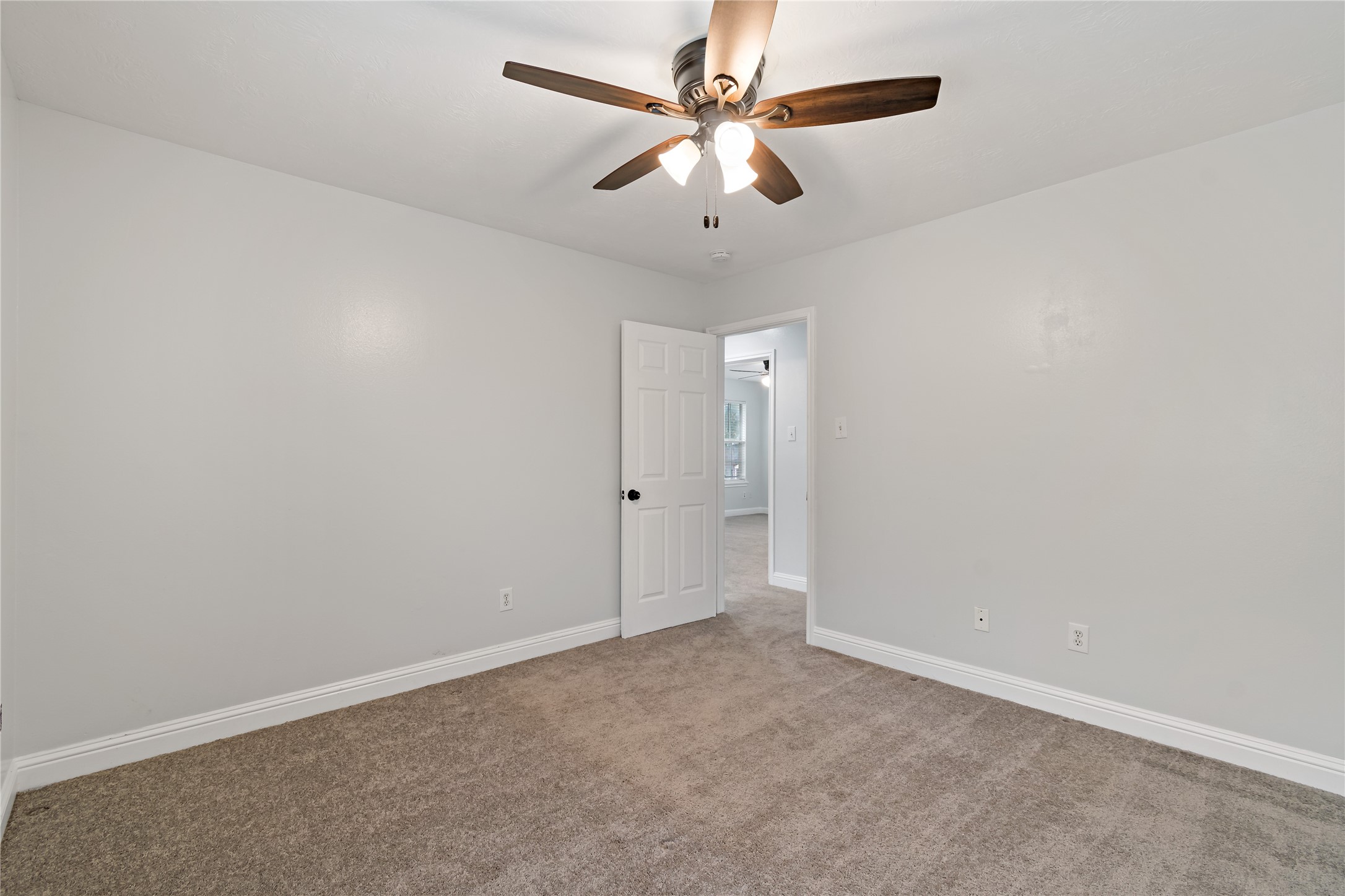 507 Firnat Street Houston, TX 77022 - Photo 13 of 22 an empty room with a window and a fan