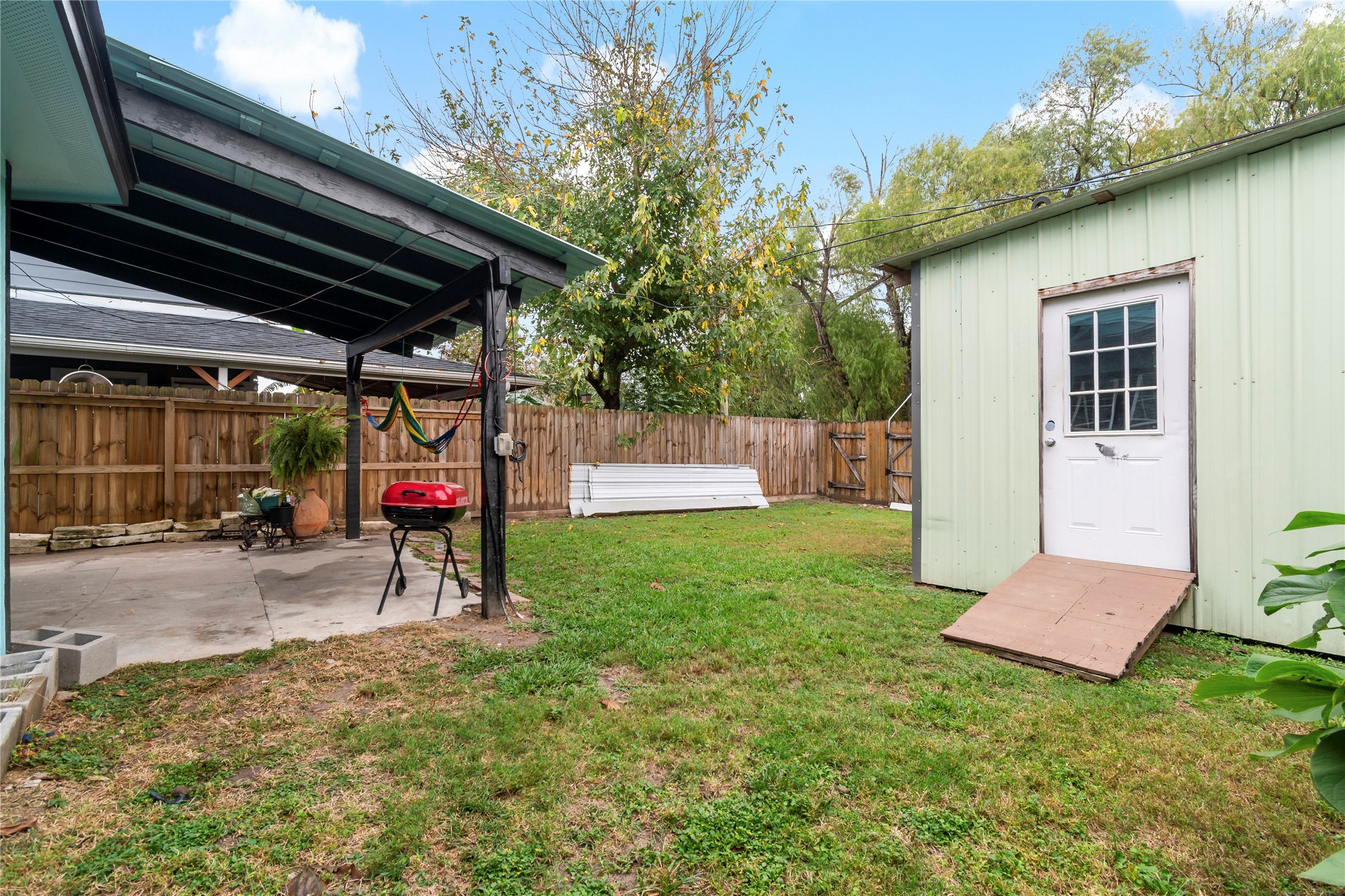 507 Firnat Street Houston, TX 77022 - Photo 17 of 22 a view of a backyard with a small cabin and chair