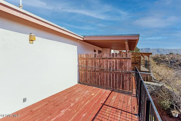 a view of a balcony with wooden floor