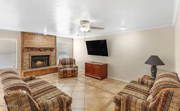 a living room with furniture a flat screen tv and a fireplace