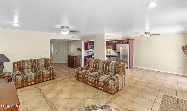 a living room with furniture and a chandelier