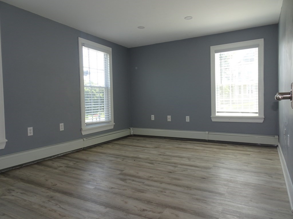 416 Crescent Avenue Chelsea, MA 02150 - Photo 13 of 21 an empty room with wooden floor and windows