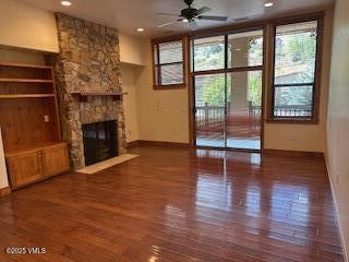 295 Main Street, Unit R204 Edwards, CO 81632 - Photo 3 of 9 a view of a livingroom with wooden floor a fireplace and window