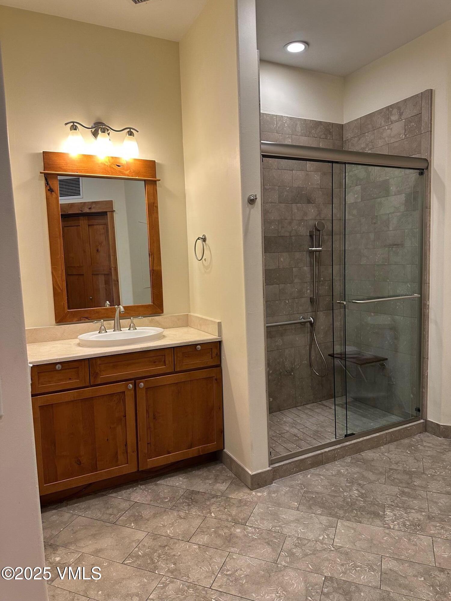 295 Main Street, Unit R204 Edwards, CO 81632 - Photo 7 of 9 a bathroom with a sink and a mirror