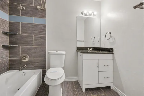 a bathroom with a toilet a sink and bathtub