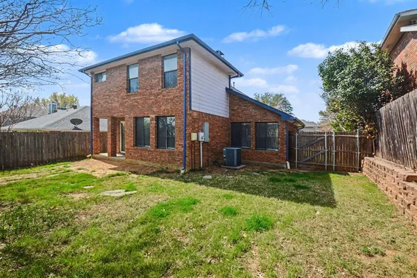 a view of a house with backyard and a fence