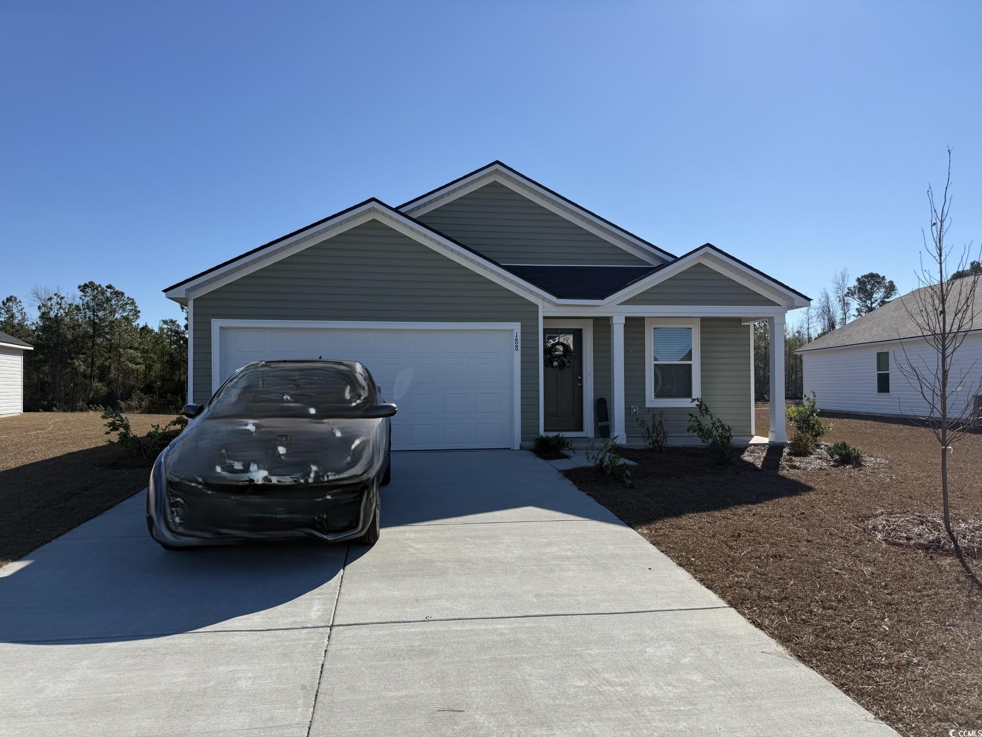 Single story home with driveway and a garage