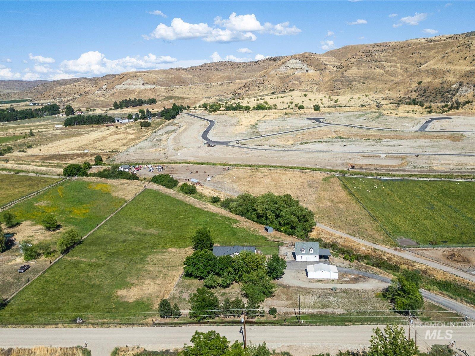 3540 Wills Road Emmett, ID 83617 - Photo 3 of 36 Expansive agricultural land featuring a two-story residence with a dormer roof and a detached outbuilding