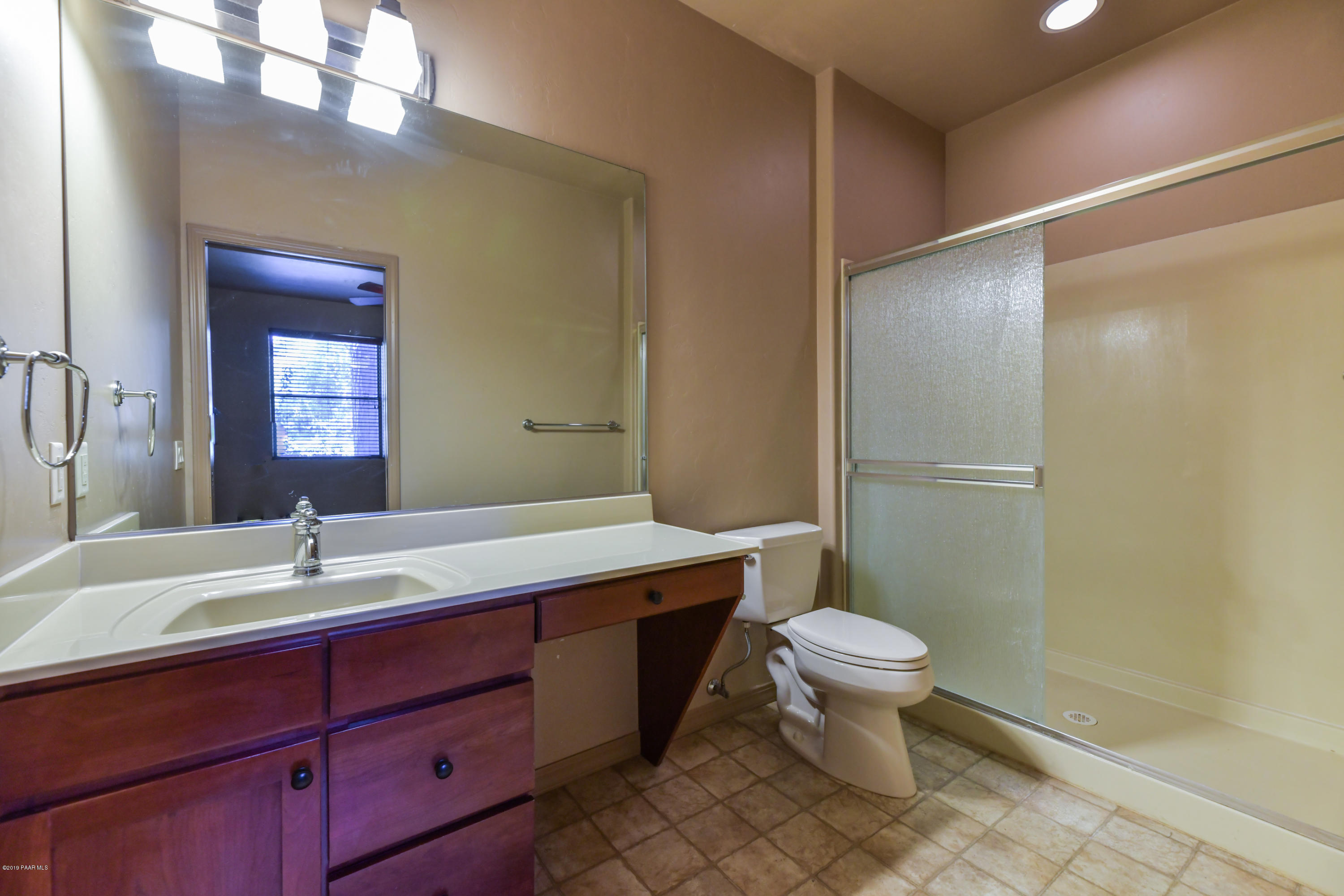 1408 East Valley View Road Prescott, AZ 86303 - Photo 36 of 76 a bathroom with a double vanity sink toilet and a mirror