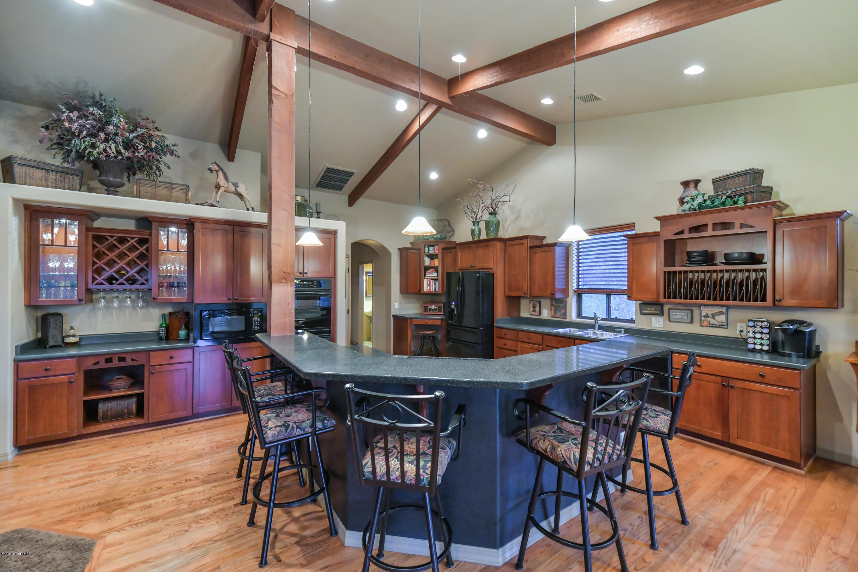 1408 East Valley View Road Prescott, AZ 86303 - Photo 54 of 76 a kitchen with stainless steel appliances a dining table chairs and wooden floor