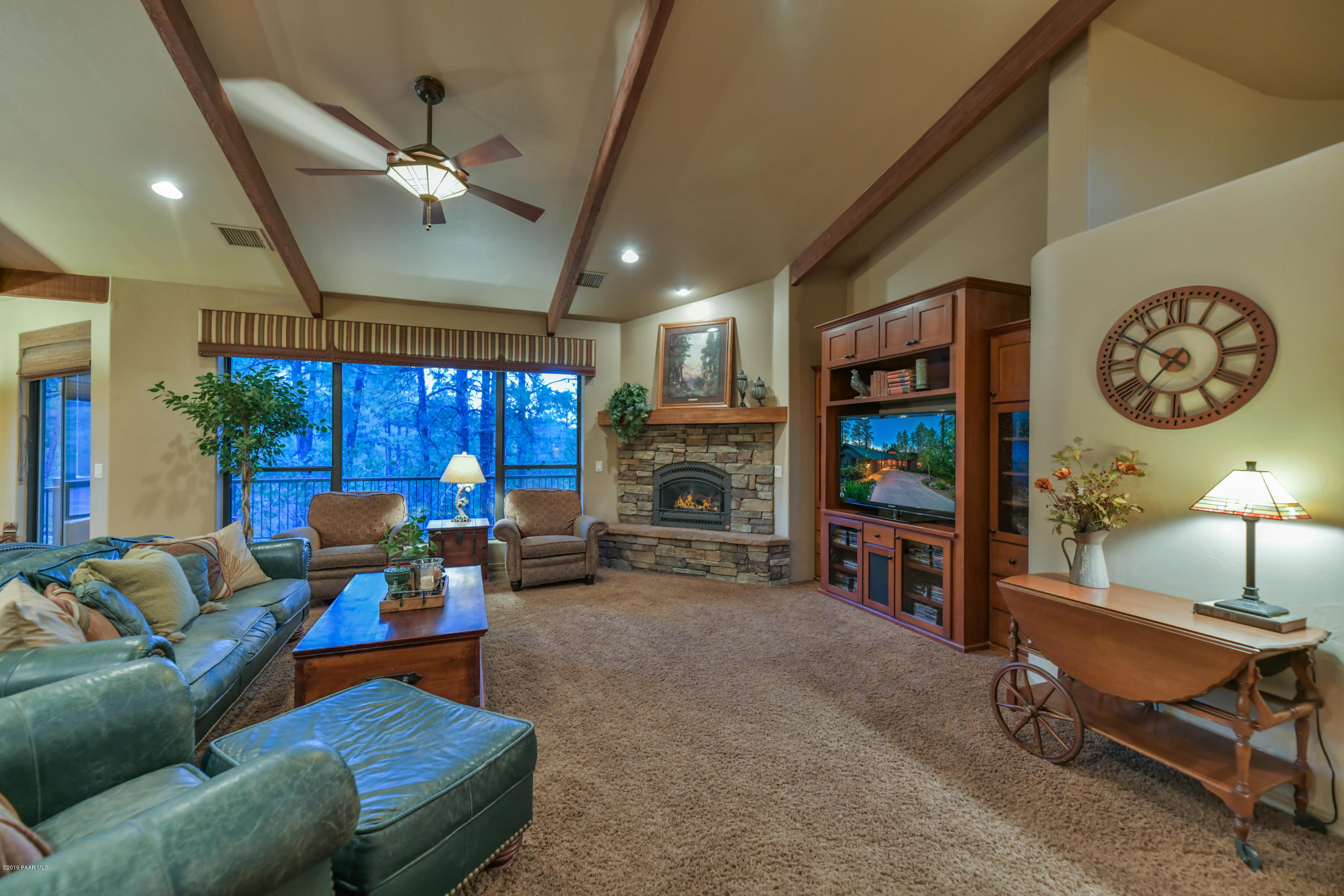 1408 East Valley View Road Prescott, AZ 86303 - Photo 62 of 76 a living room with furniture a ceiling fan and a fireplace