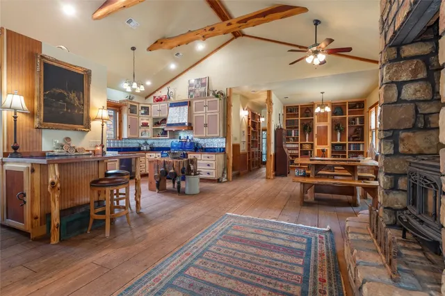a living room with lots of furniture and kitchen view