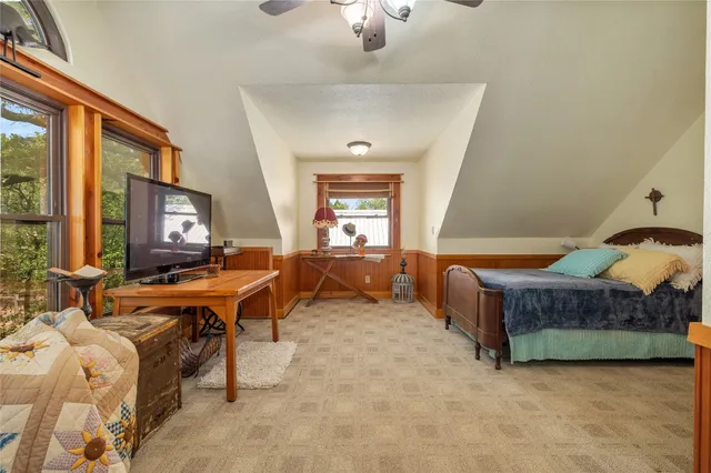 a living room with a bed furniture and a large window