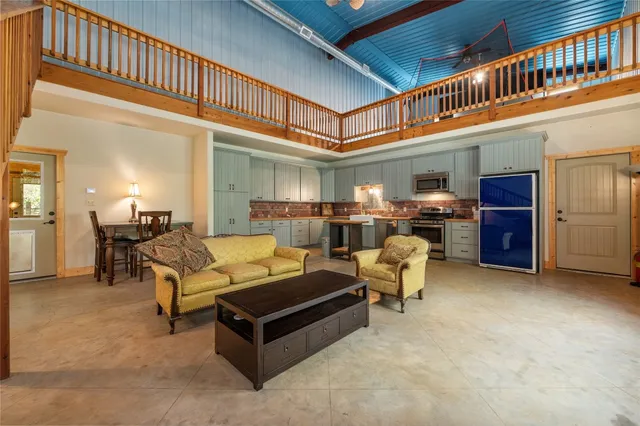 a living room with furniture and a pool table