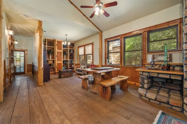 a living room with patio furniture and a wooden floor