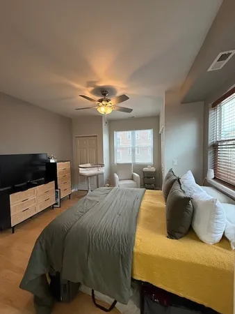 a bedroom with a bed and window