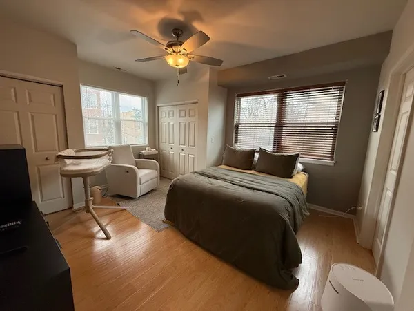 a bedroom with furniture a bed and a large window