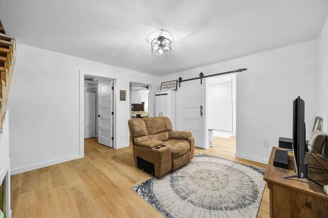 a spacious bedroom with a bed and a flat screen tv