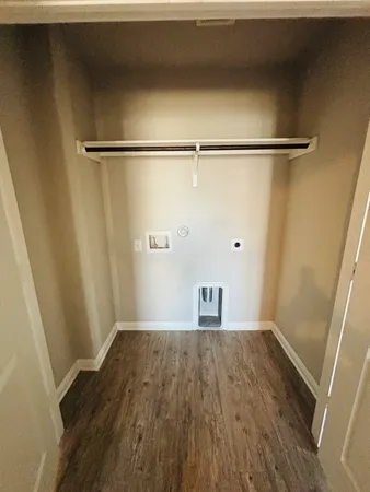 a view of a room with wooden floor and a window