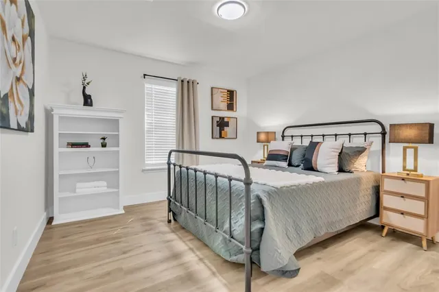 a bedroom with a bed and a window