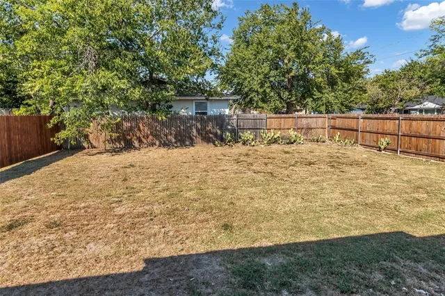 a view of a backyard of the house