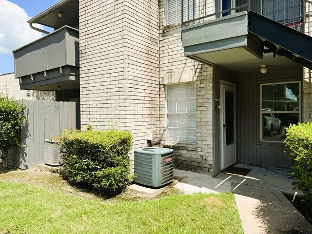 a view of a patio with table and chairs and potted plants