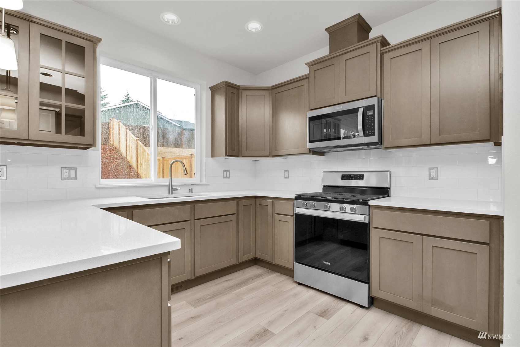 9727 9th Avenue Southeast Lacey, WA 98513 - Photo 11 of 38 a kitchen with stainless steel appliances granite countertop a stove microwave and sink