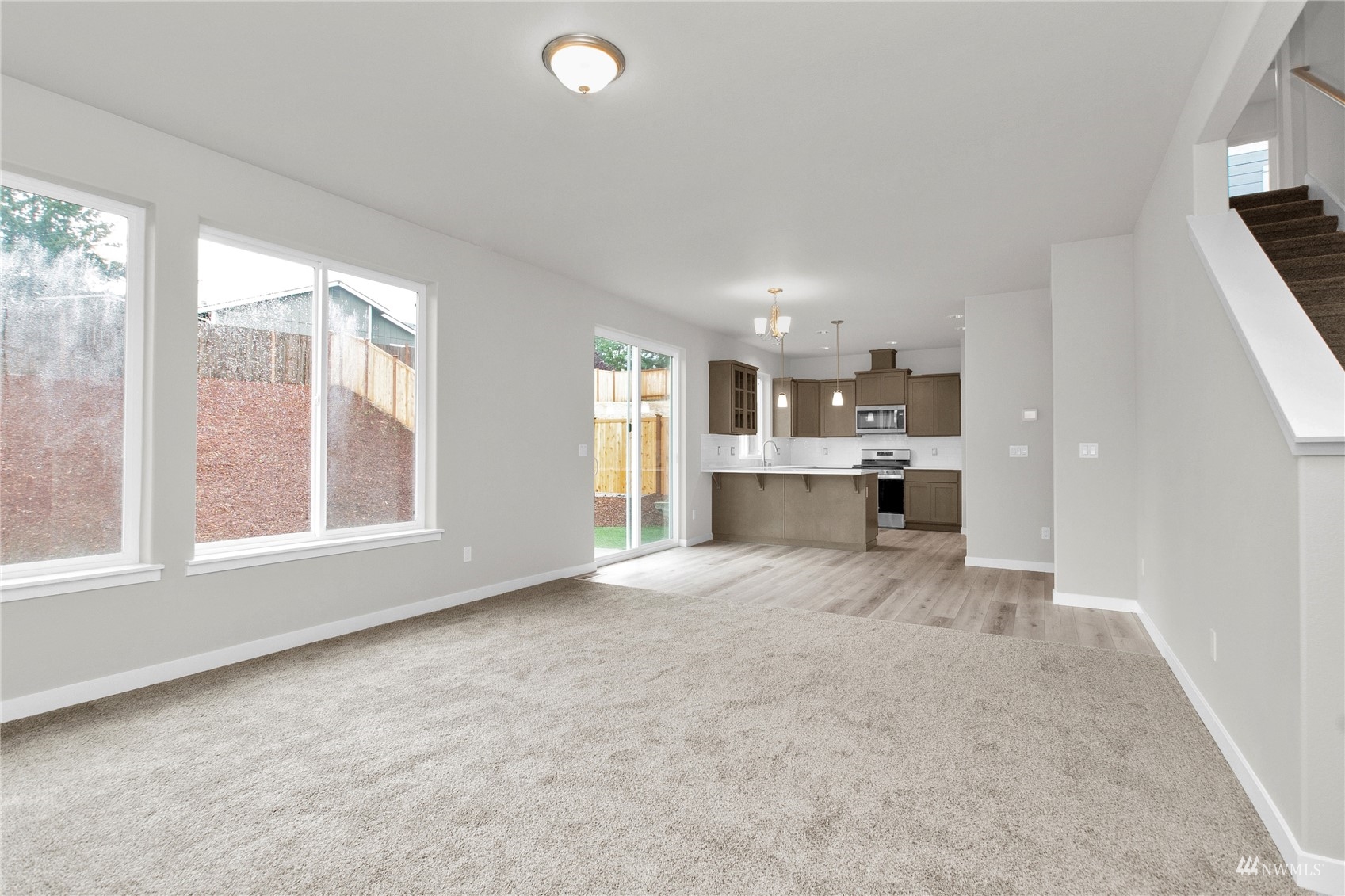 9727 9th Avenue Southeast Lacey, WA 98513 - Photo 14 of 38 an empty room with windows and view of kitchen