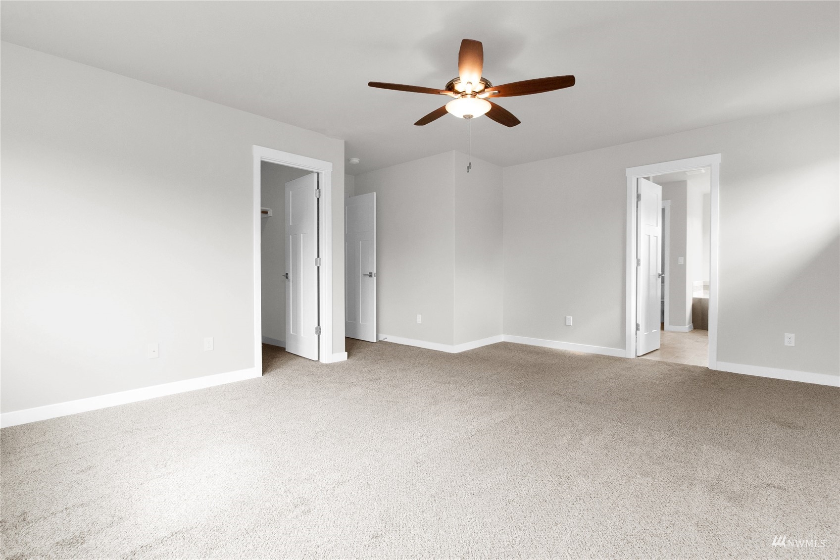 9727 9th Avenue Southeast Lacey, WA 98513 - Photo 33 of 38 a view of an empty room with a chandelier fan