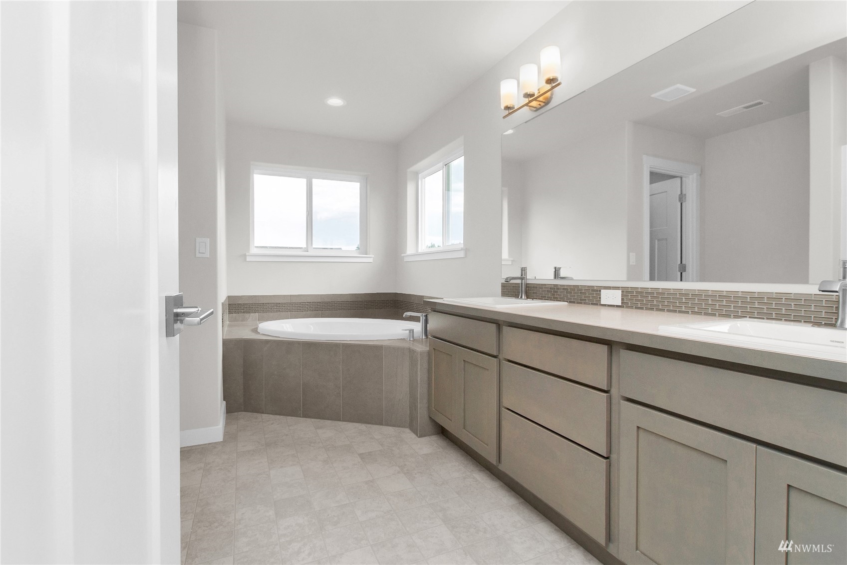 9727 9th Avenue Southeast Lacey, WA 98513 - Photo 34 of 38 a bathroom with a sink vanity tub and a mirror