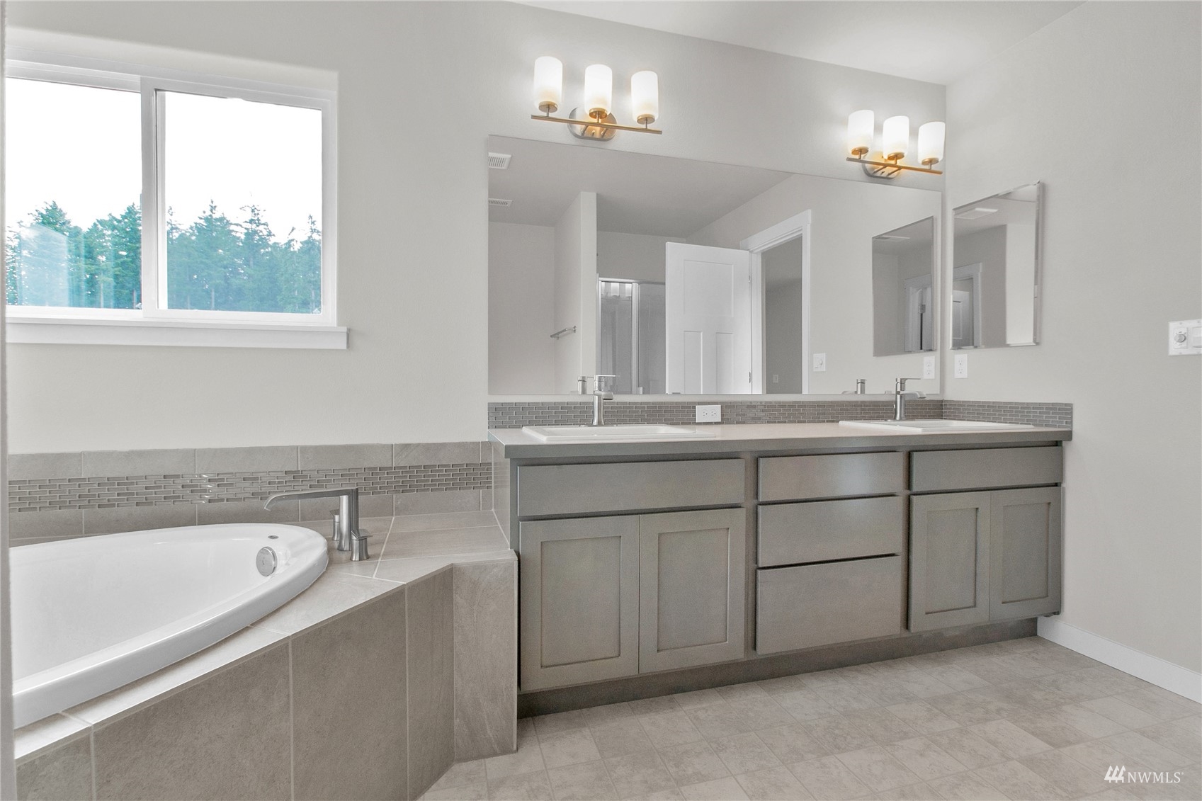 9727 9th Avenue Southeast Lacey, WA 98513 - Photo 35 of 38 a bathroom with a sink tub double vanity and a mirror
