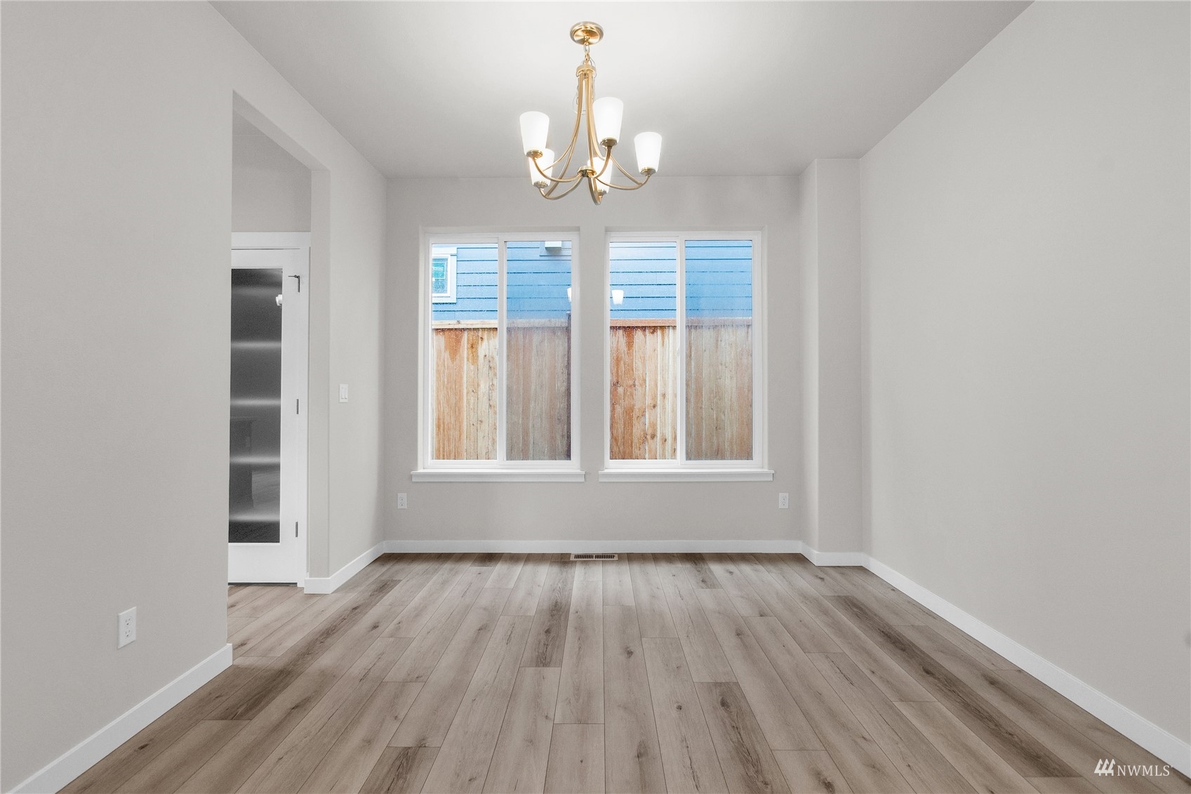 9727 9th Avenue Southeast Lacey, WA 98513 - Photo 9 of 38 a view of an empty room with wooden floor and a window