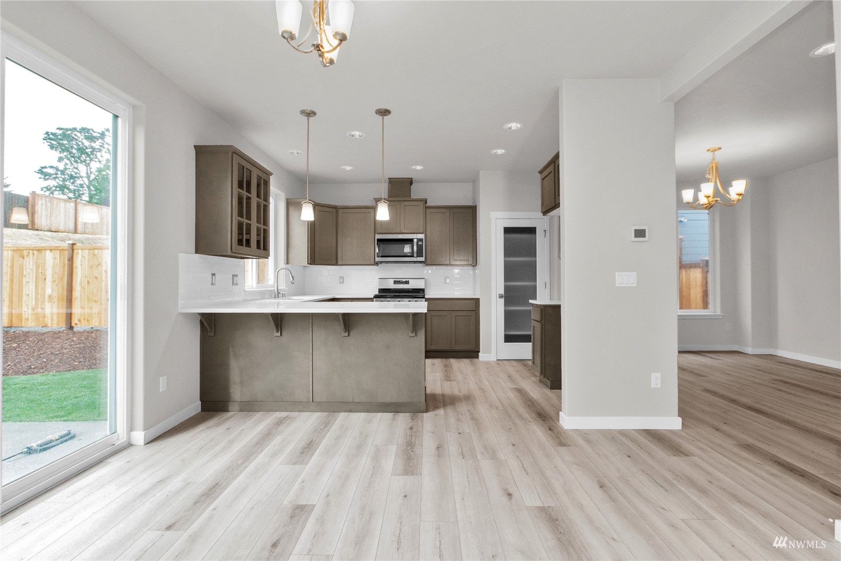 9727 9th Avenue Southeast Lacey, WA 98513 - Photo 10 of 38 a large kitchen with stainless steel appliances kitchen island granite countertop a large cabinets a sink and a stove