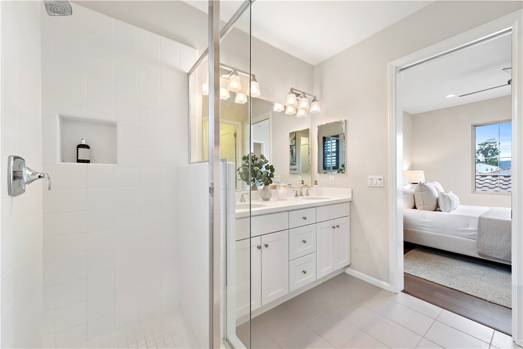 113 Painted Trellis Irvine, CA 92620 - Photo 16 of 26 a spacious bathroom with a double vanity sink mirror and bathtub