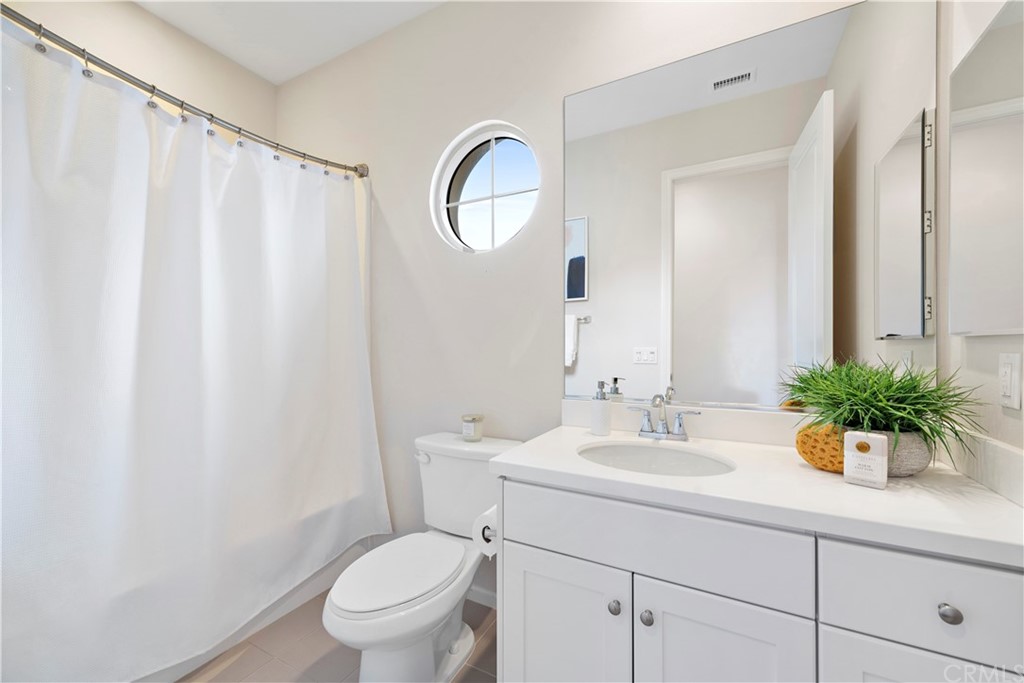113 Painted Trellis Irvine, CA 92620 - Photo 19 of 26 a bathroom with a sink a toilet and a mirror