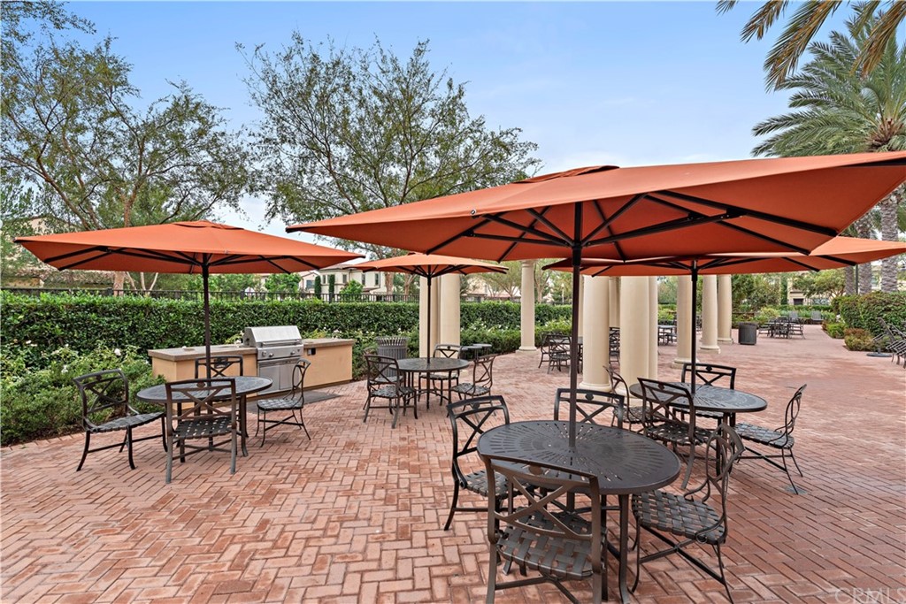 113 Painted Trellis Irvine, CA 92620 - Photo 23 of 26 a view of patio with chairs and table under an umbrella