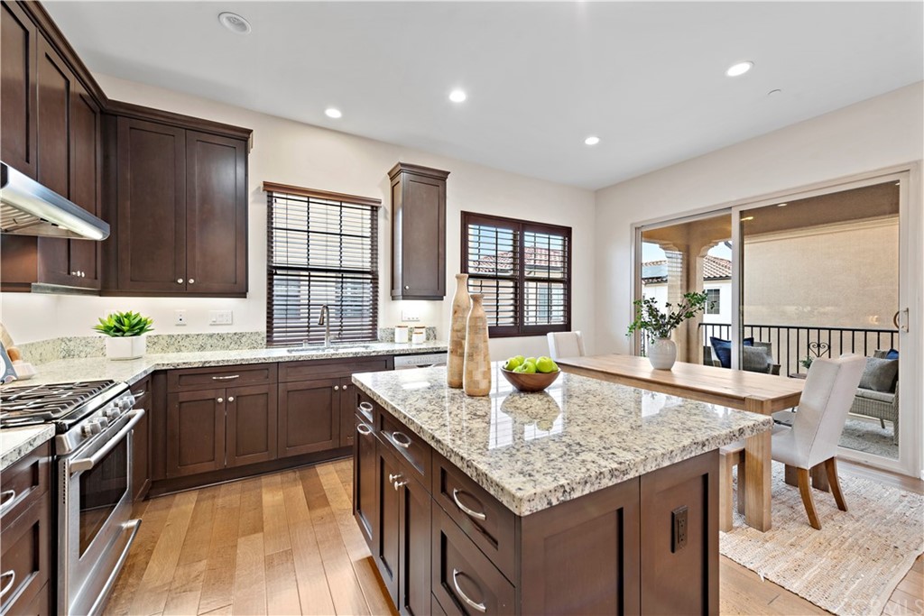 113 Painted Trellis Irvine, CA 92620 - Photo 7 of 26 a kitchen with granite countertop sink stove and cabinets