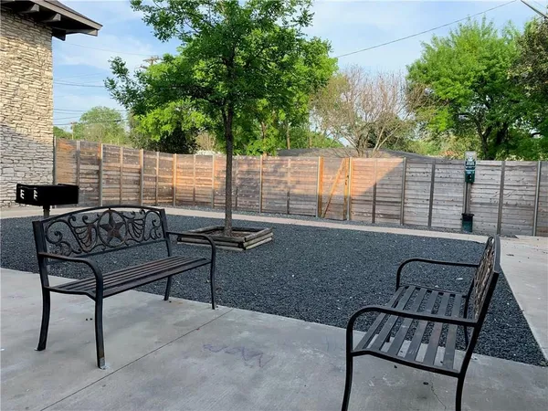 a view of a chairs and tables in the backyard